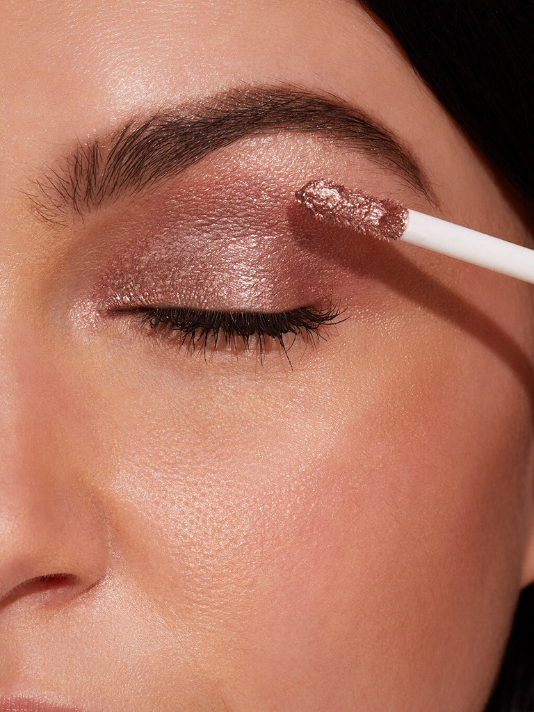 cha ching -- close up of brunette model applying chadelier shimmer shadow