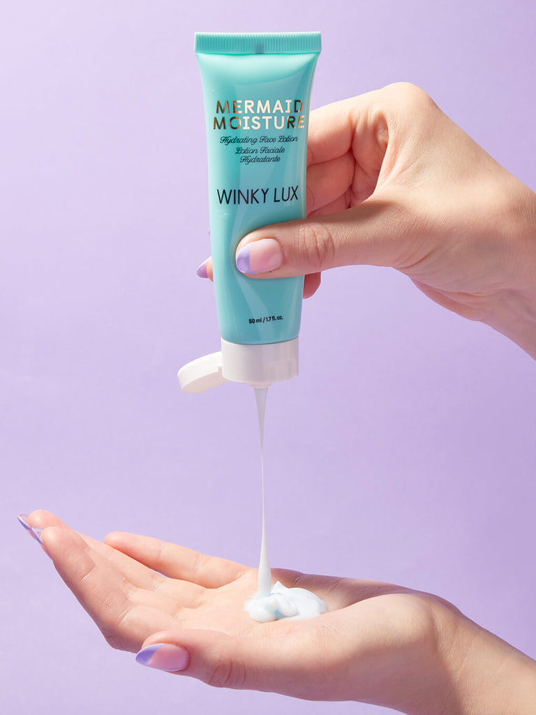 hand squeezing mermaid hydrating face lotion into other hand