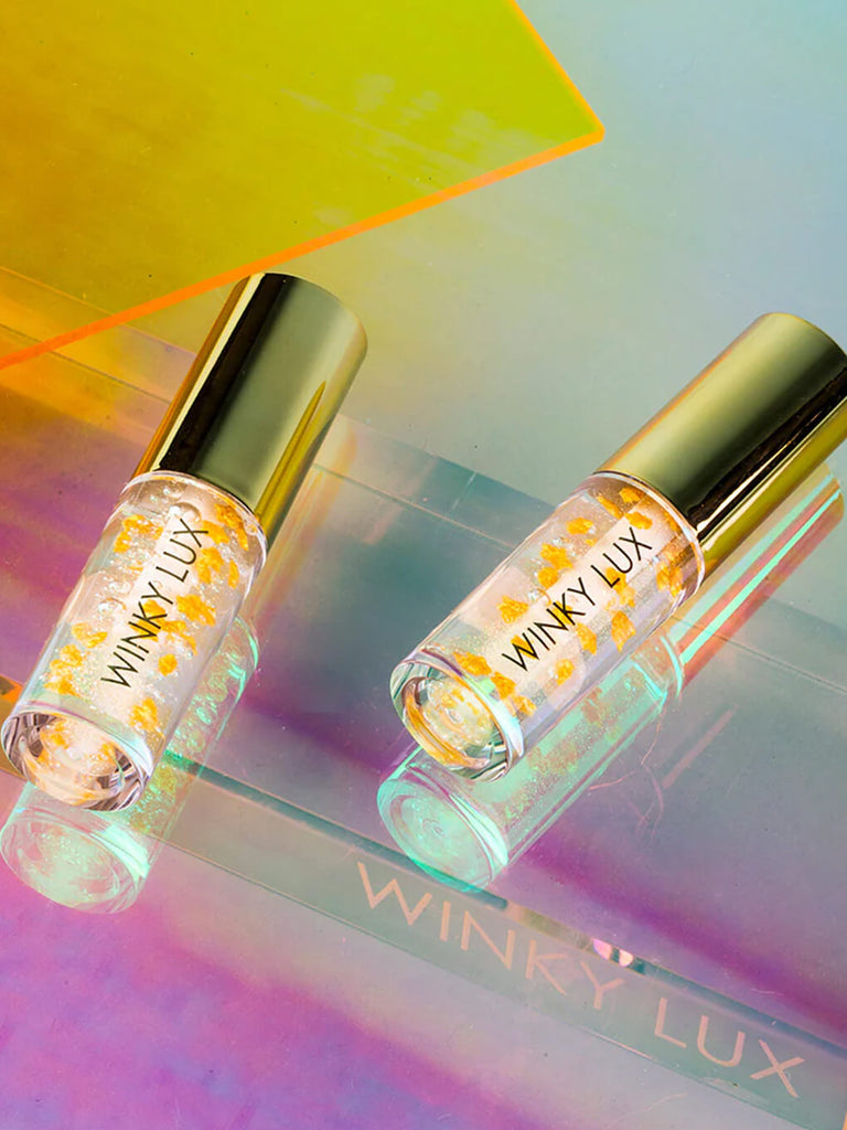 in the stars nourishing lip oils flat lay on colorful background