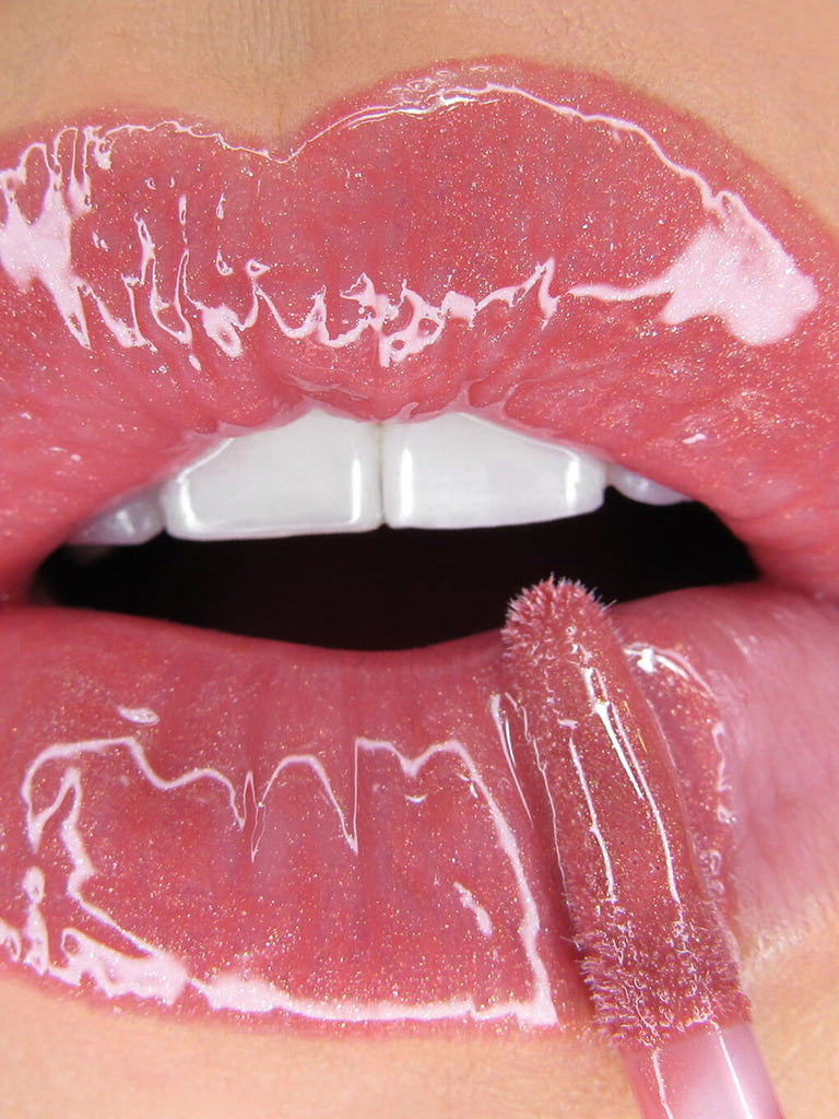 Meow -- close up of model applying glossy boss lip gloss to lips