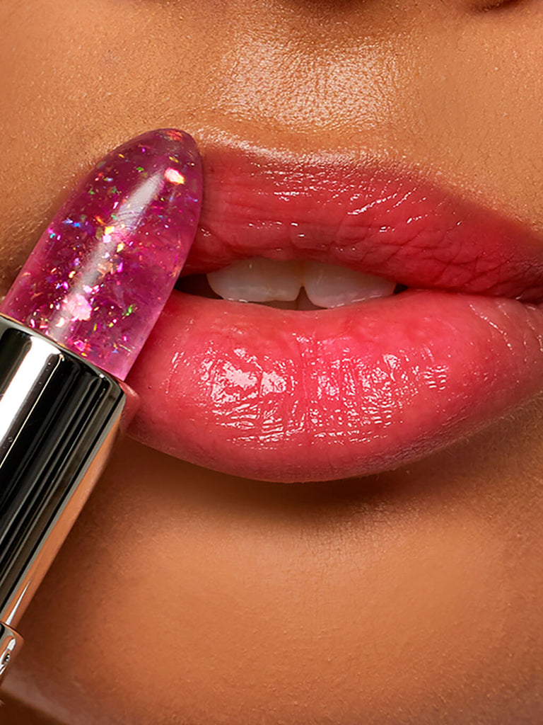 lavender confetti -- close up of model applying glitter confetti ph balm on lips