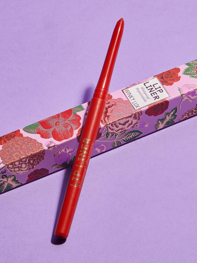 dirty love -- waterproof lip liner resting on box on purple background