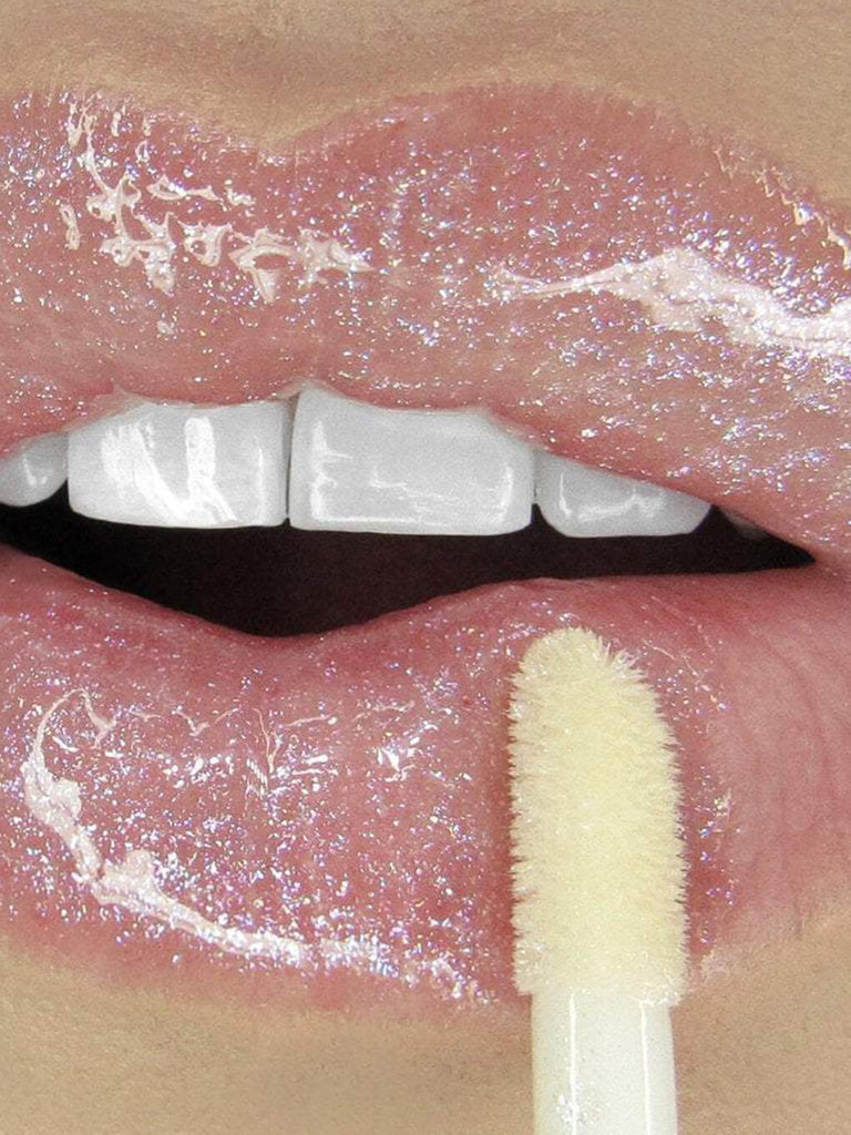 Birthday Cake -- close up of model applying glossy boss lip gloss to lips