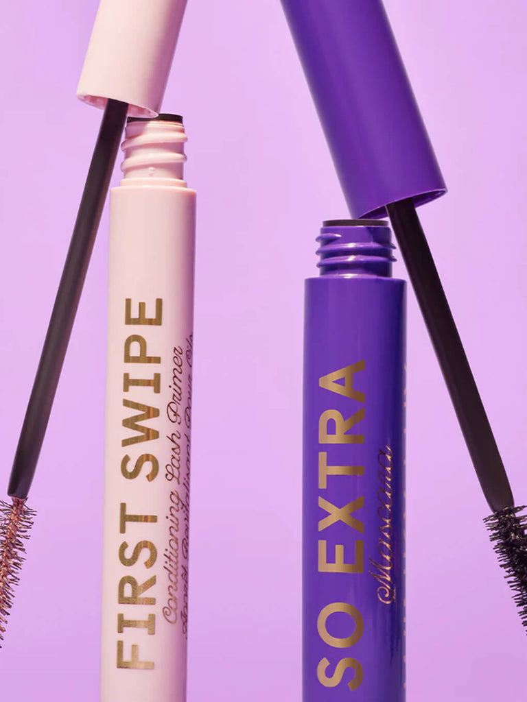 first swipe conditioning lash primer and so extra volumizing mascara standing up with caps leaning on top