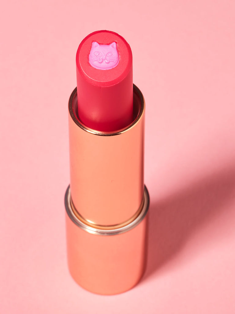 Kiss & Tail -- purrfect pout sheer lipstick standing up on pink background