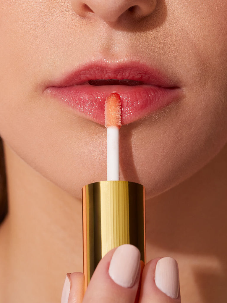 flush -- barely there tinted lip oil close up applying to models lips