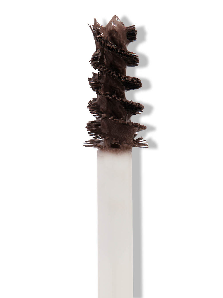 black -- close up of unibrow tinted brow gel brush on white background 