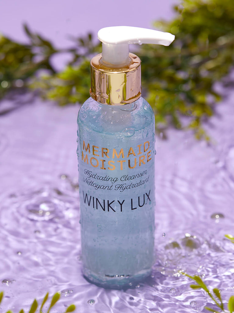 mermaid moisture hydrating face cleanser sitting in water with seaweed in the background