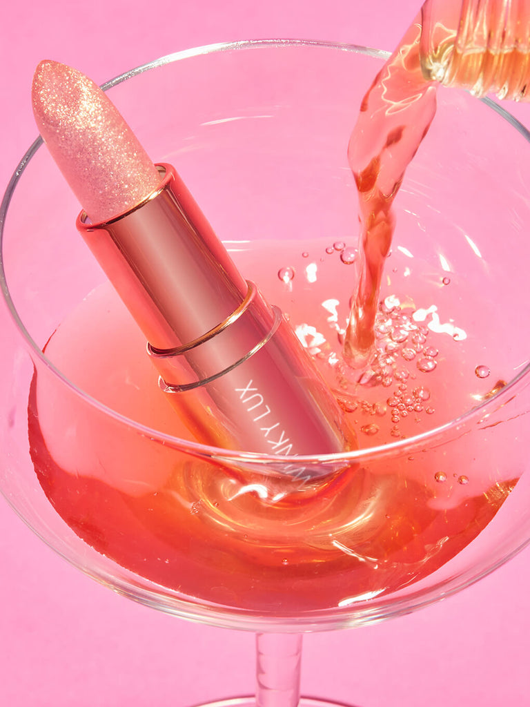 Rosé glimmer -- rosé glimmer ph balm in a glass with Rosé pouring in