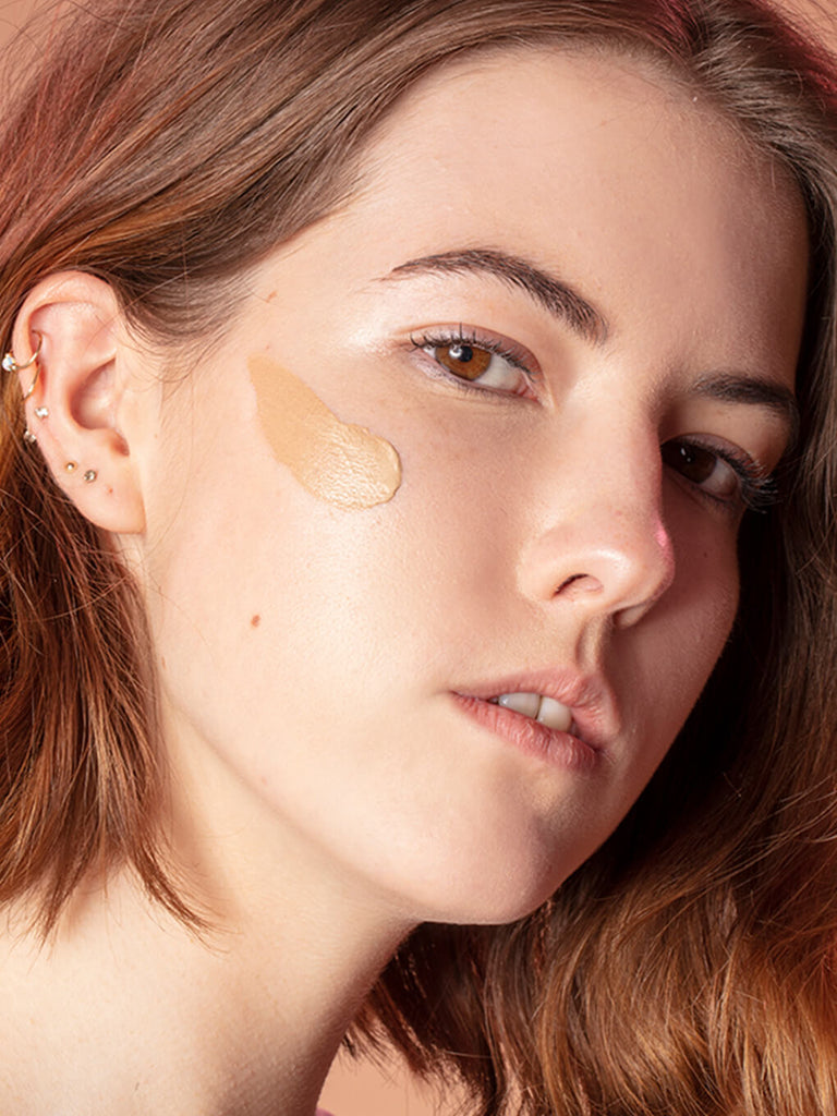 Light -- close up of brunette model with tinted moisturizer spf 30 on her cheek bone