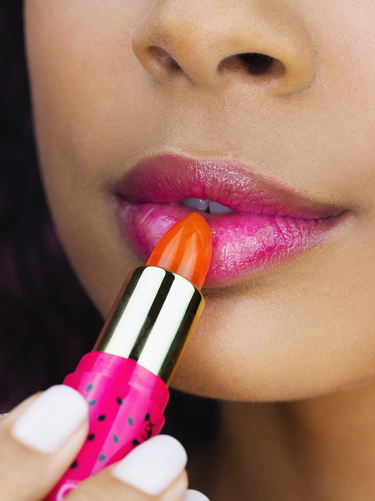 close up of brunette model applying watermelon jelly ph lip balm