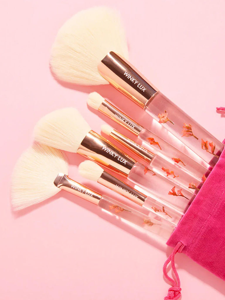 forever flower makeup brush 6 piece set coming out of pink bag on pink background