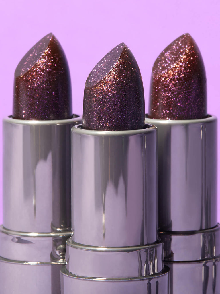 trio of aurora ph lip balms on purple background