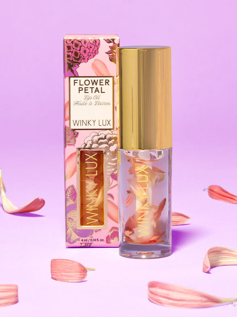 flower petal lip oil box and product next to each other surrounded by petals