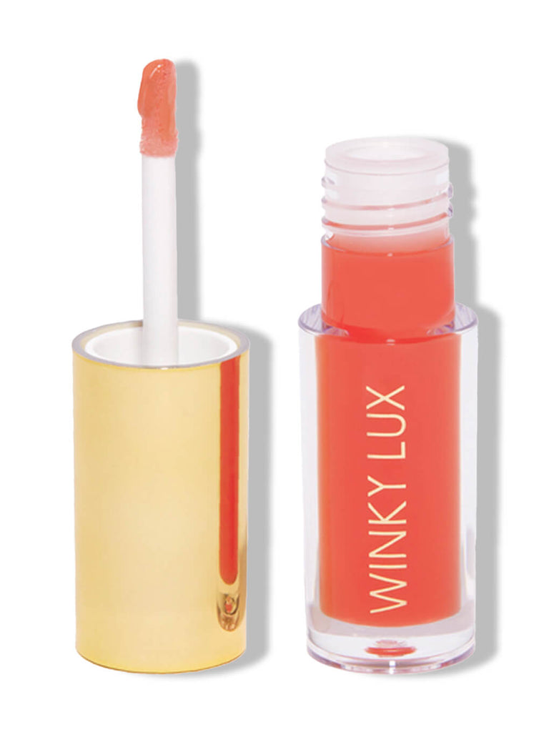 flush -- barely there tinted lip oil with cap next to bottle on white background