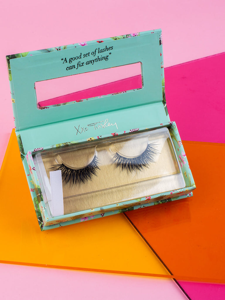 everything -- fake eyelashes in box with lid open flat lay on pink background
