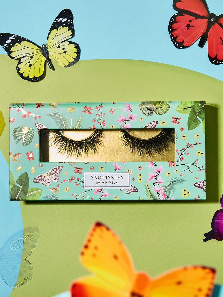 everything -- fake eyelashes in box flat lay with butterflies surrounding
