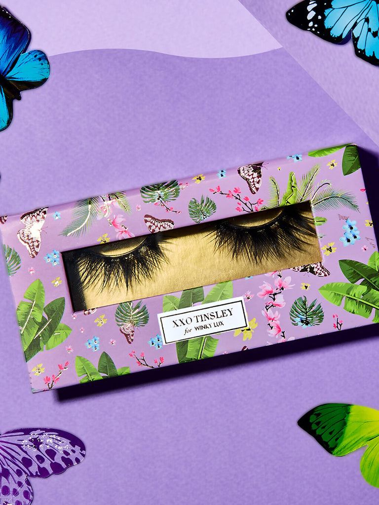 graduate -- fake eyelashes in box flat lay with butterflies surrounding
