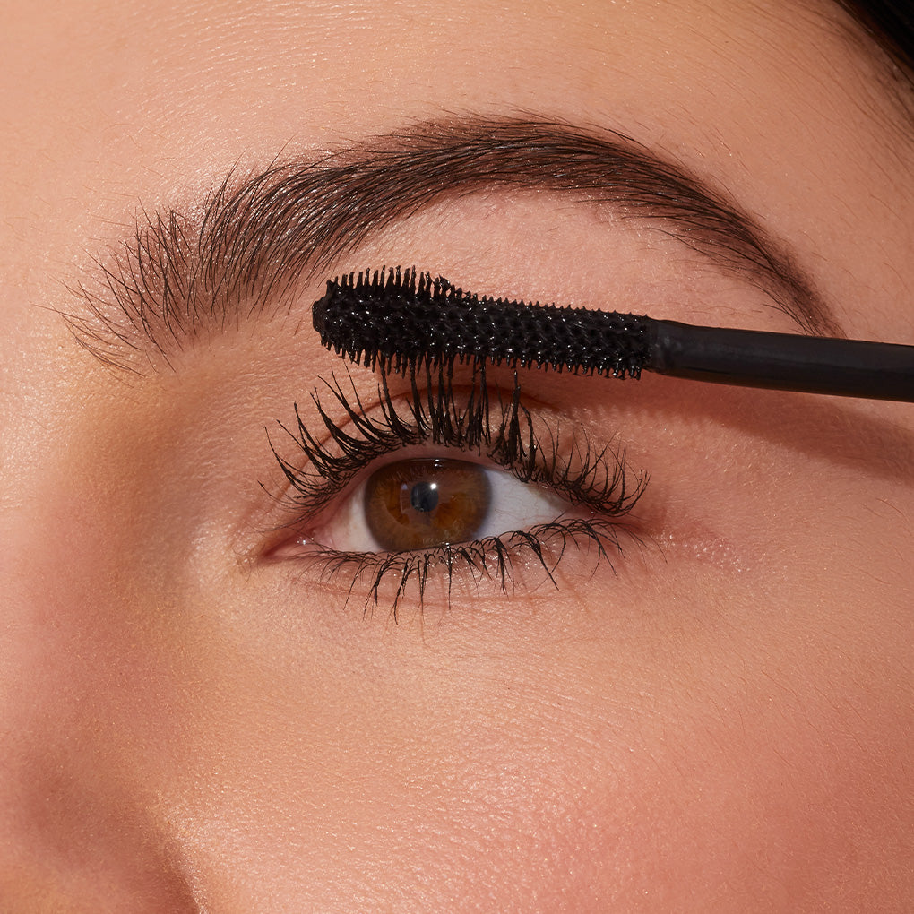 Line and Define Set -- close up of model applying extravalash bold black mascara to eyelashes